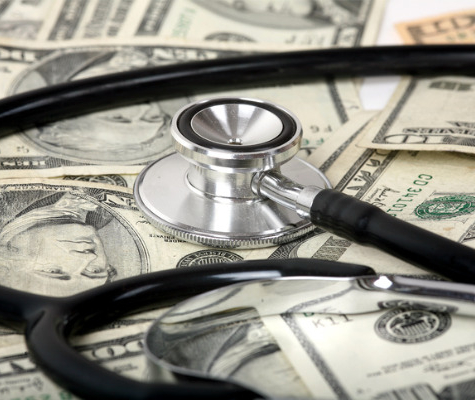 Image of stethoscope on top of ten dollar bills