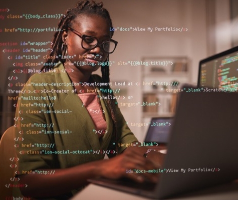 Image of woman working on computer with code overlaid on top of image