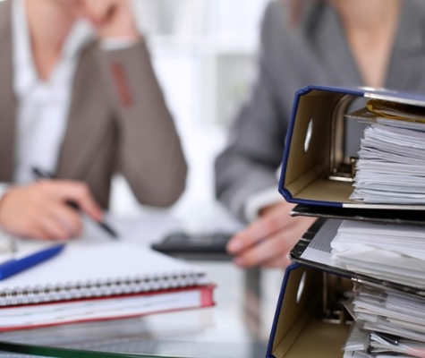 Image of binders with blurred people in the background