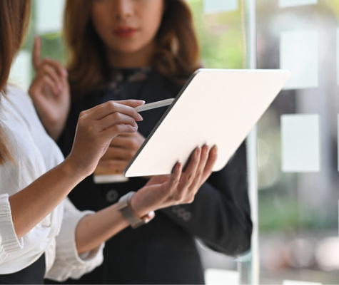 Image of two women discussing over a tablet