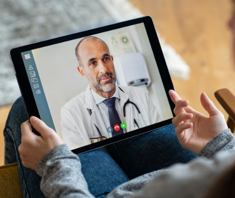 Image of tablet as doctor talks on a telehealth appointment